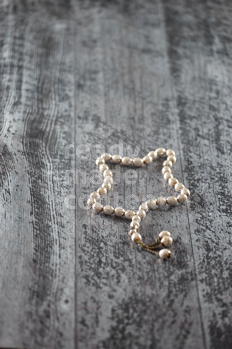 A prayer beads placed on wooden background