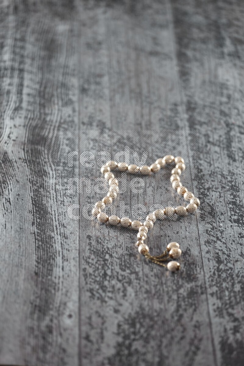 A prayer beads placed on wooden background