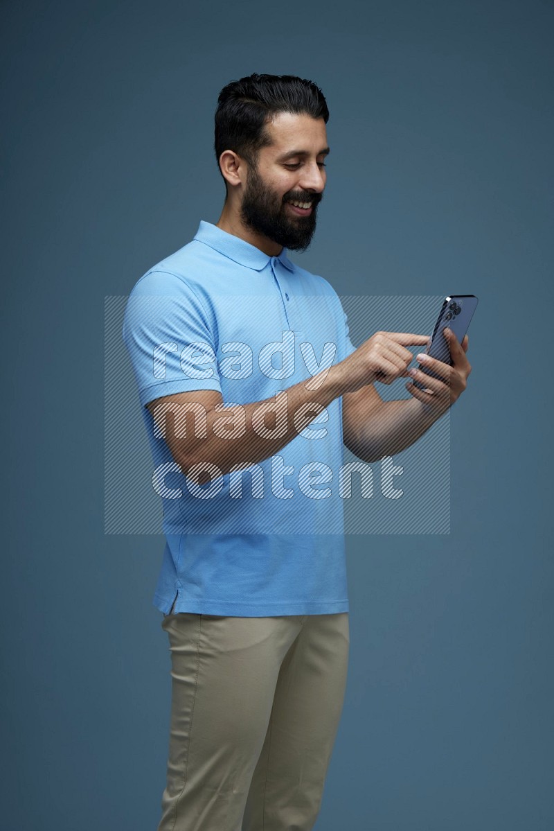 A man Swiping in a blue background wearing a Blue shirt