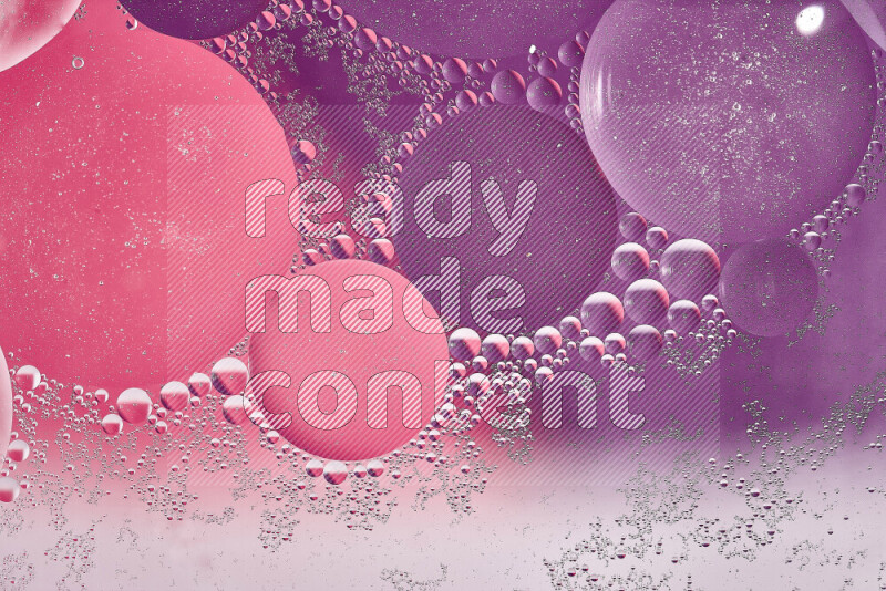 Close-ups of abstract oil bubbles on water surface in shades of white, purple and pink