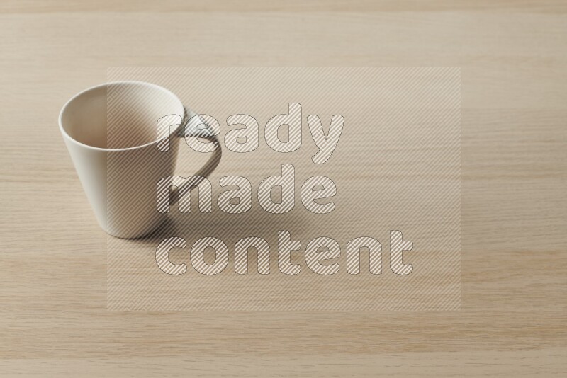 A white ceramic mug on light wooden background