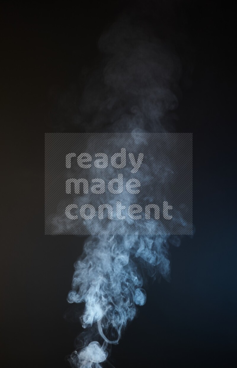 Heavy smoke in blue and yellow isolated on black background
