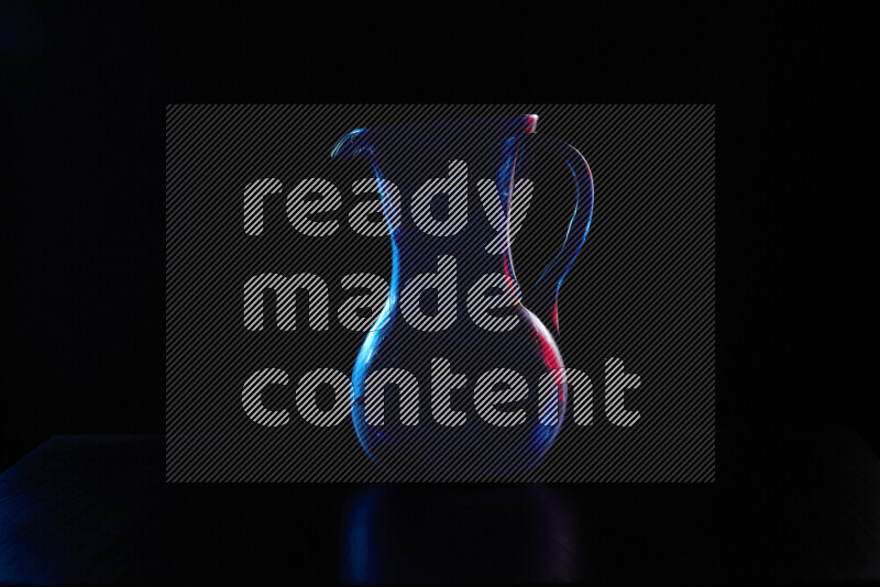 Glassware with rim light in red and blue against black background