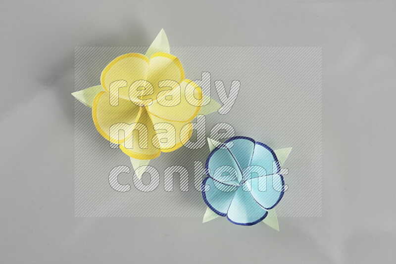 Origami flower on grey background