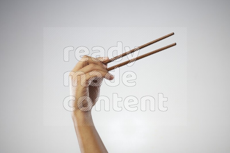 Male Hand Holding Chop Stick on white background