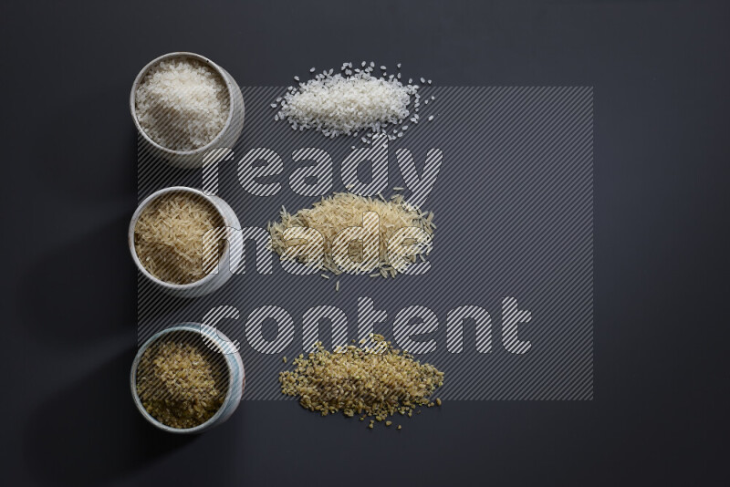 Legumes in pottery bowls on grey background