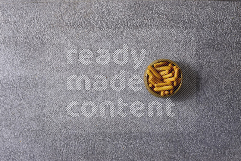 Assorted snacks in pottery bowls on grey background