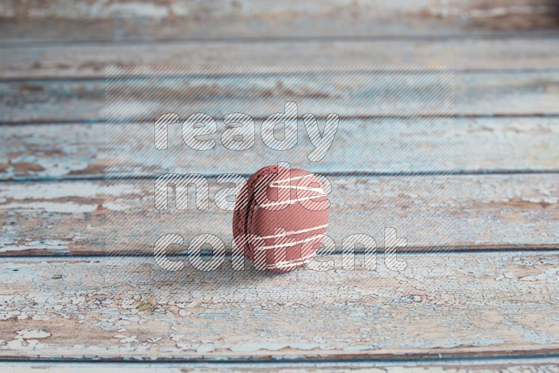 45º Shot of Red Poppy Flower macaron on light blue wooden background