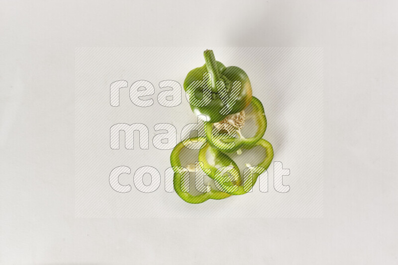 Green bell pepper slices on white background