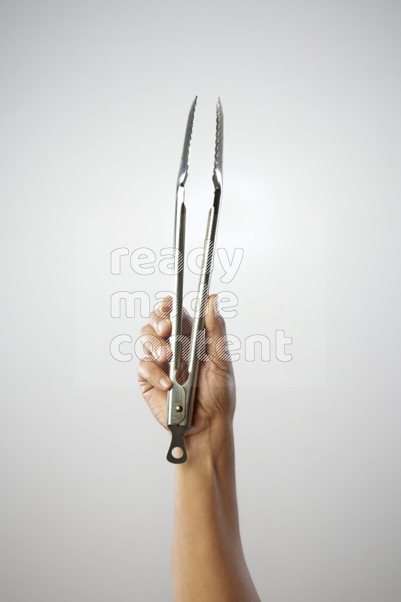 Male Hand Holding Tongs on white background