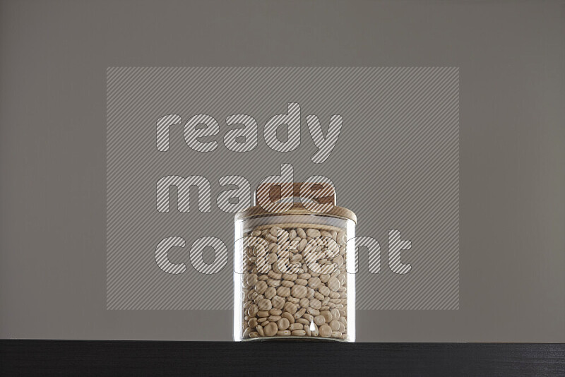 Lupin Beans in a glass jar on black background