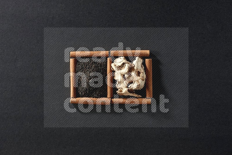 2 squares of cinnamon sticks full of dried ginger and black tea on black flooring