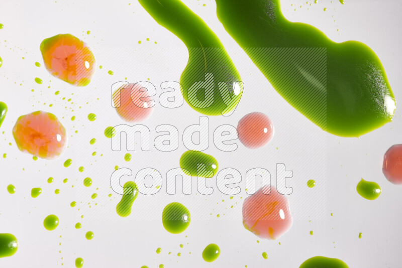 Close-ups of abstract red and green paint droplets on the surface