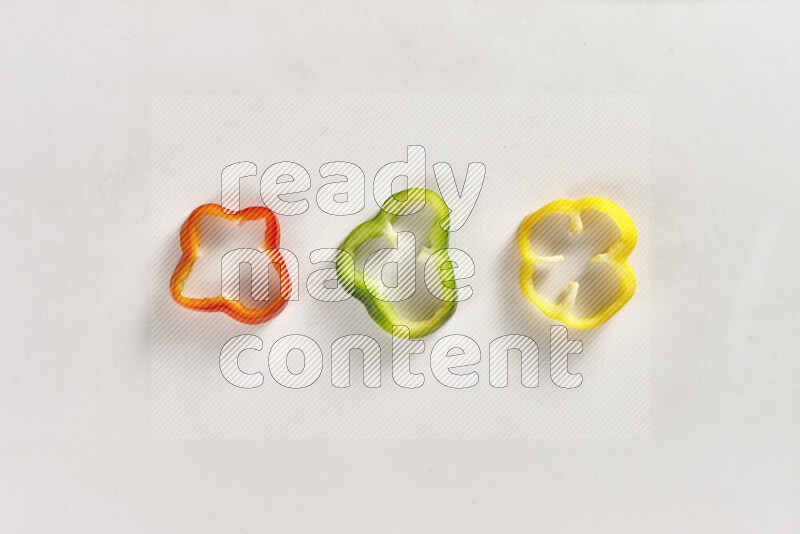 Assorted bell pepper slices on white background