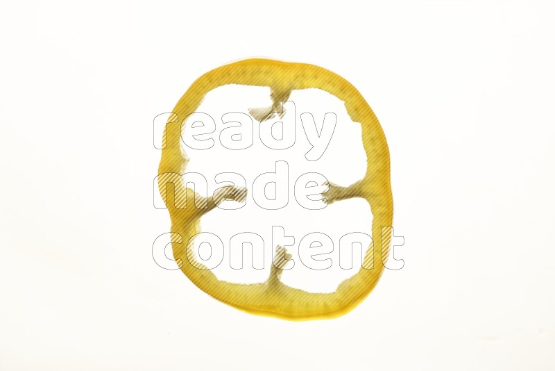 Yellow bell pepper slices on illuminated white background