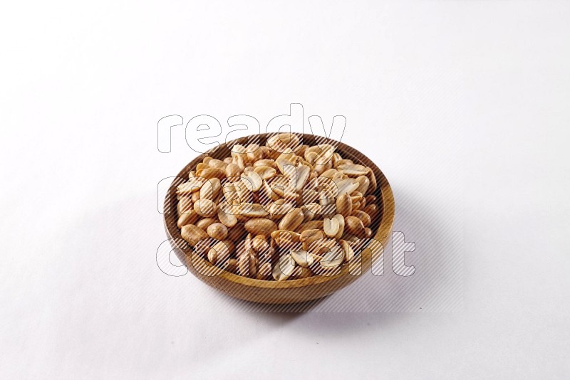 Peanuts in a wooden bowl on white background