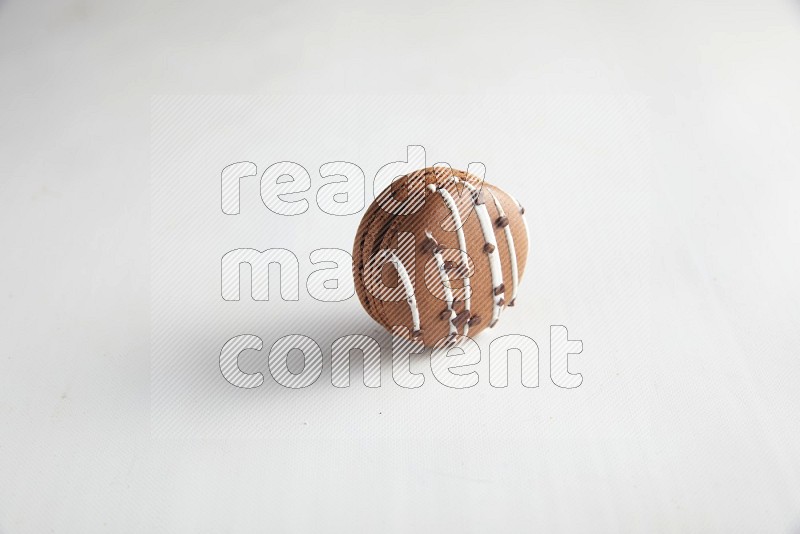 45º Shot of Brown white Chocolate Caramel macaron on white background