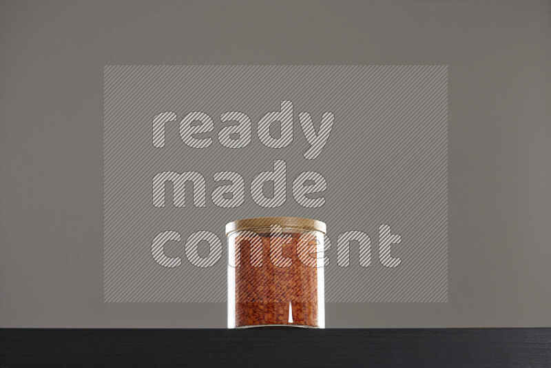 Lentils in a glass jar on black background