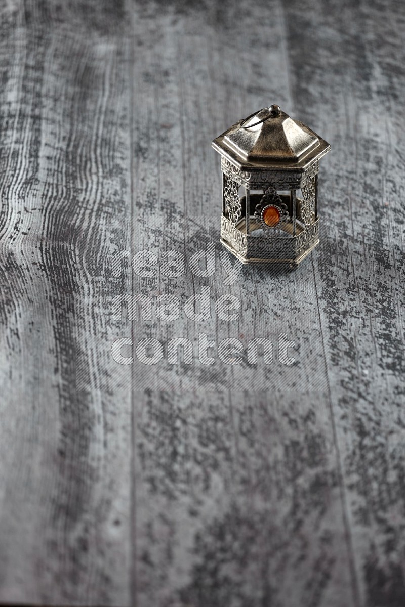 A lantern placed on a wooden background