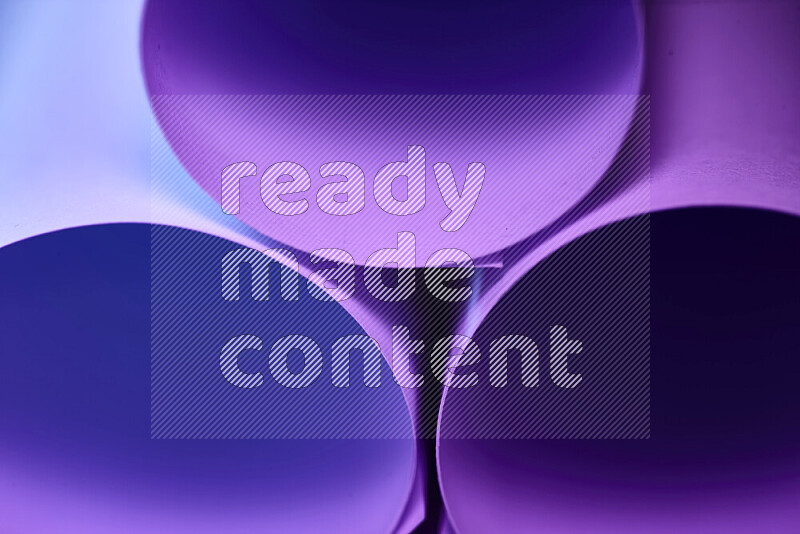 The image shows an abstract paper art with circular shapes in varying shades of purple