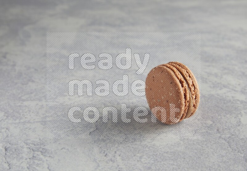 45º Shot of Brown Hazelnuts macaron on white  marble background