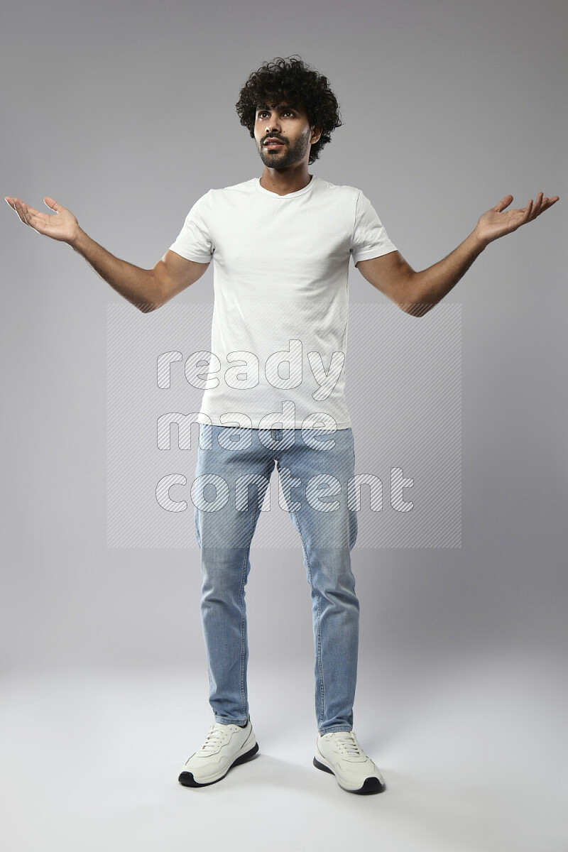 A man wearing casual standing and making a hand gesture on white background