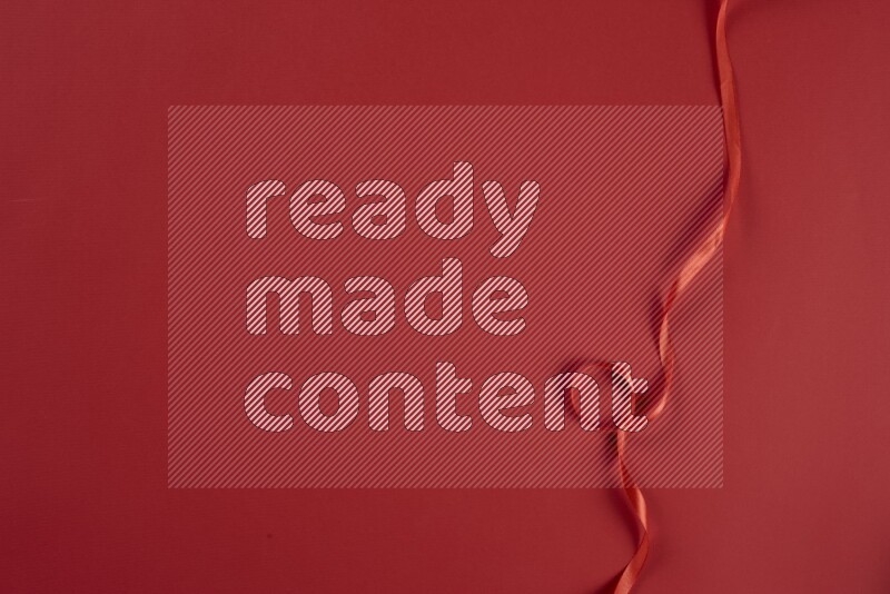 A red collection of sewing and tailoring tools arranged on a red background