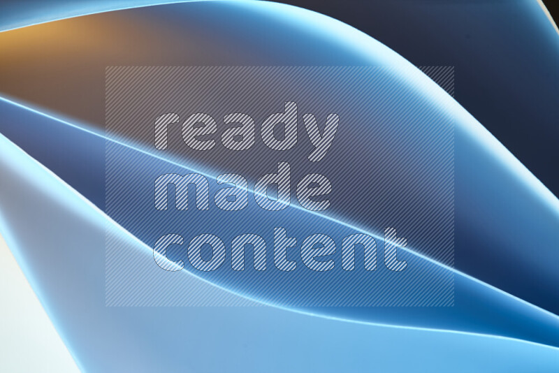 This image showcases an abstract paper art composition with paper curves in blue and yellow gradients created by colored light