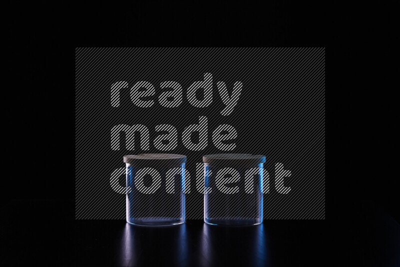 Glassware with rim light in blue and white against black background