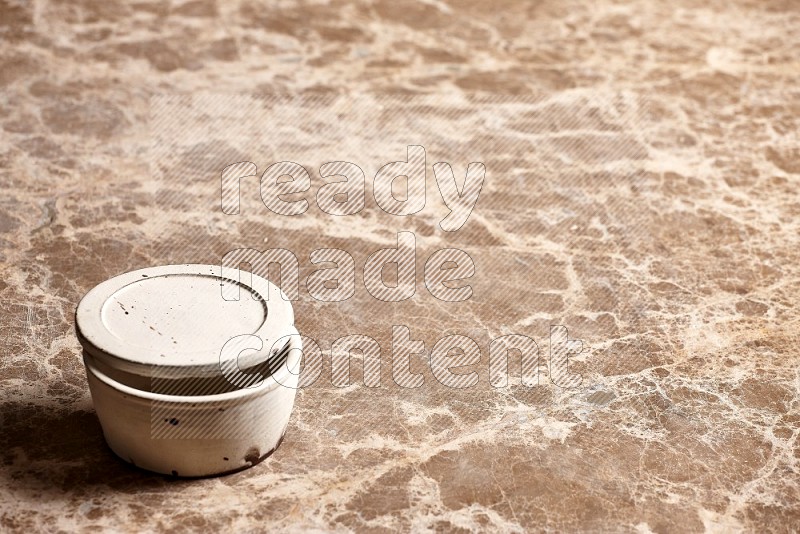 White Pottery Bowl on Beige Marble Flooring, 45 degrees