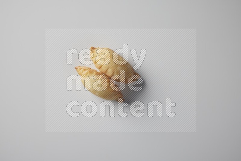 Two fried sambosa from a top angle on a white background