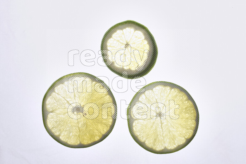 Orange slices on illuminated white background