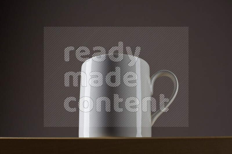 Low angle shot of a white cup on grey background