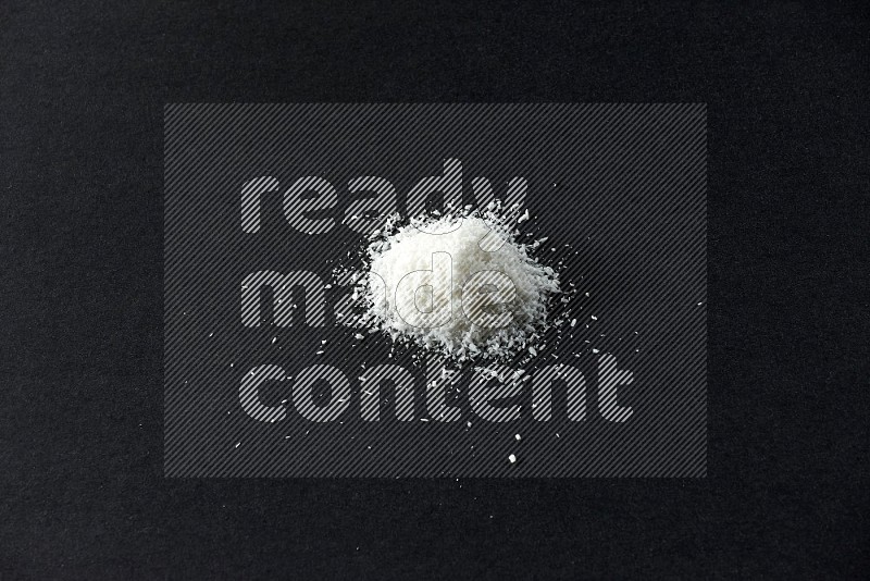 Desiccated coconut on a black background in different angles