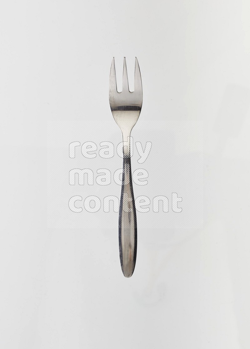 Silver stainless steel fork on white background