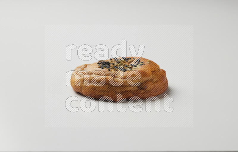 Hasawi cookie field with date and decorated by black seed and Anise grain on a white background