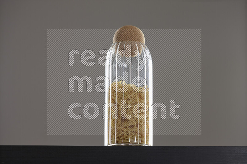 Snacks in a glass jar on black background