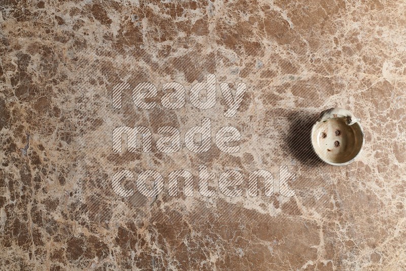 Top View Shot Of A Pottery soap dish On beige Marble Flooring