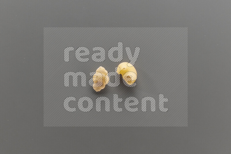 Snails pasta with other types of pasta on grey background