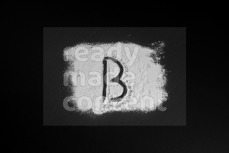 Alphabets written with powder on black background