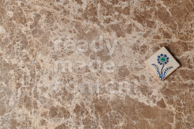 A decorative coaster on beige marble background