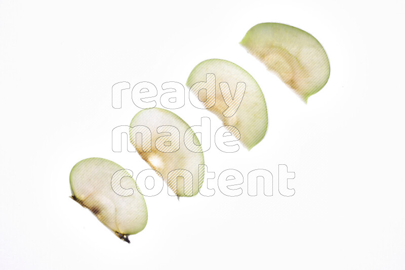 Apple slices on illuminated white background
