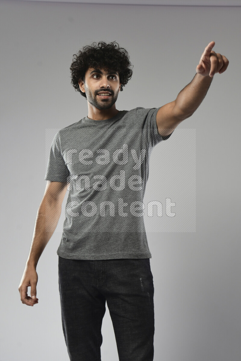 A man wearing casual standing and making a hand gesture on white background