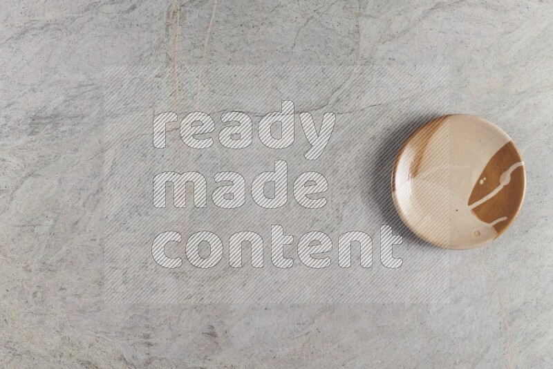 صحن فخاري متعدد الألوان على خلفية من الرخام الرمادي