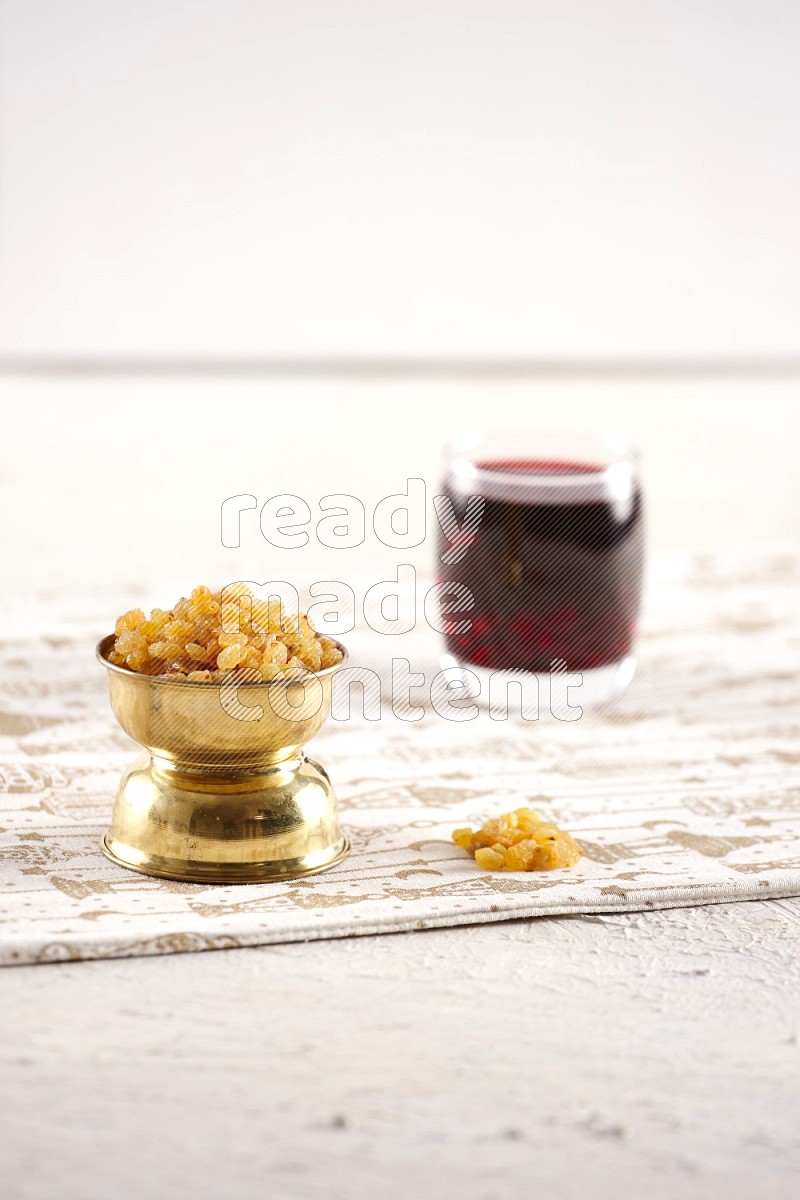 Dried fruits in a metal bowl with hibiscus in a light setup