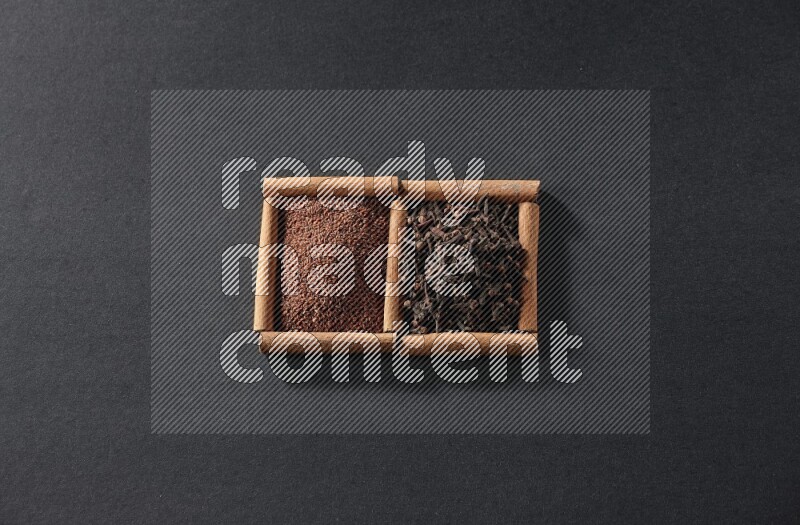 2 squares of cinnamon sticks full of garden cress and cloves on black flooring