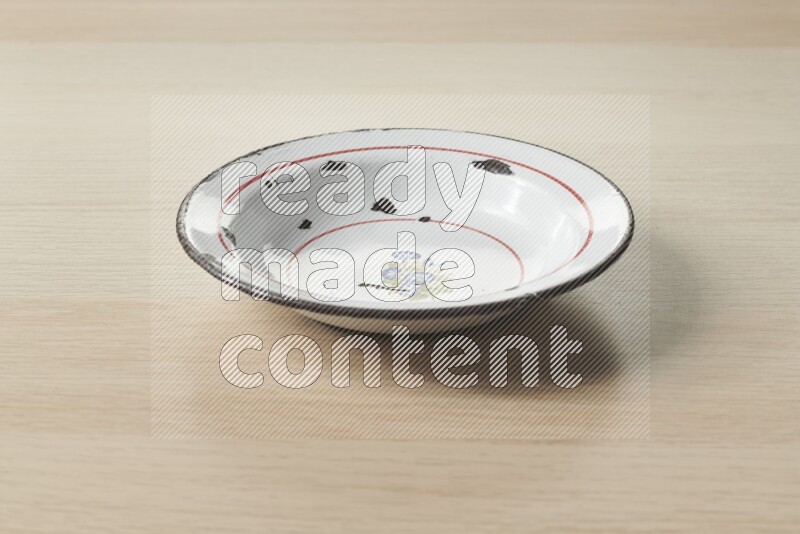 A vintage metal plate on light wooden background