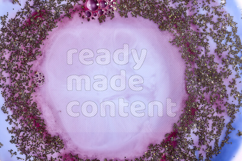 لقطة مقربة لبريق ذهبي متلألئ منتشر على خلفية من اللون الأزرق والأحمر في حركات دائرية