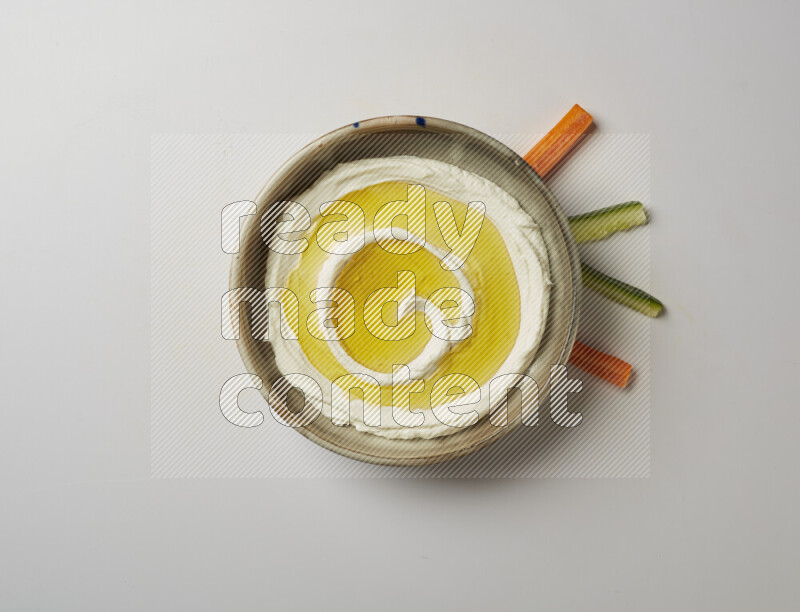 Lebnah garnished with olive oil in a grey pottery plate on a white background