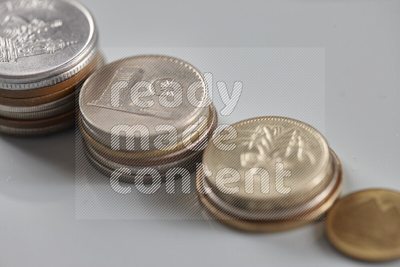 Random old coins on grey background